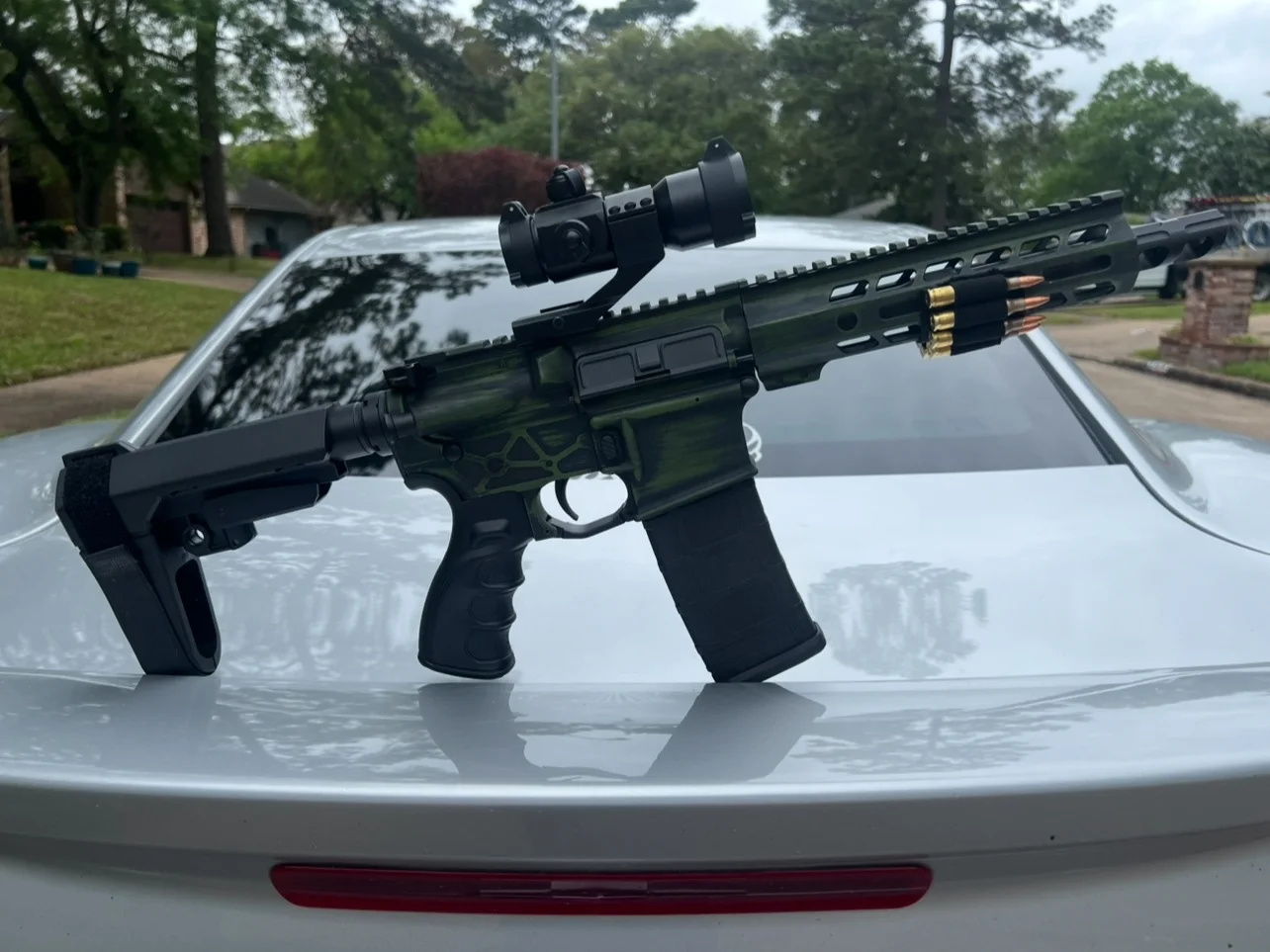 Marauder custom Cerakote AR-15 with a 7.5-inch barrel in a green and black battleworn finish by Tattoo Tactical